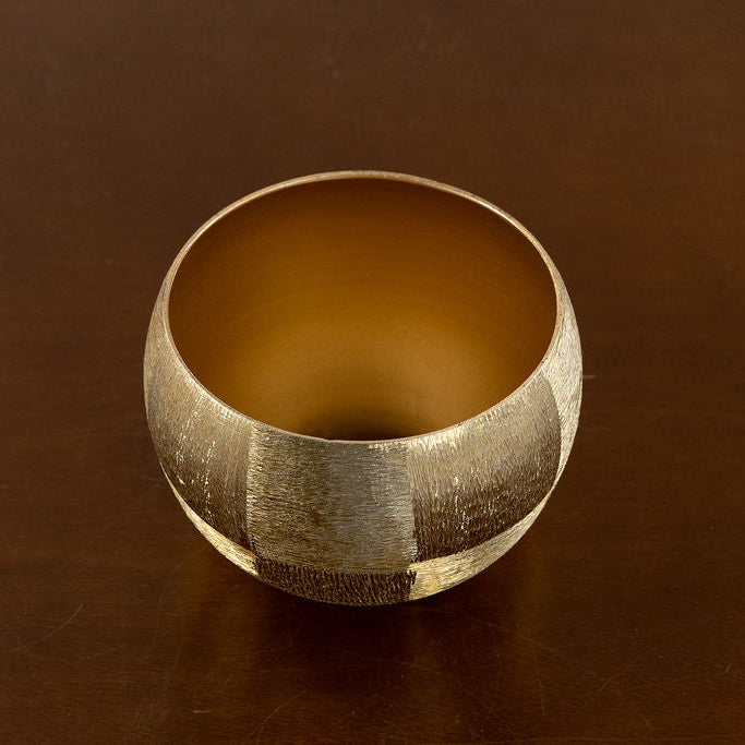 Brushed Gold Pot on a brown leather surface from above. 